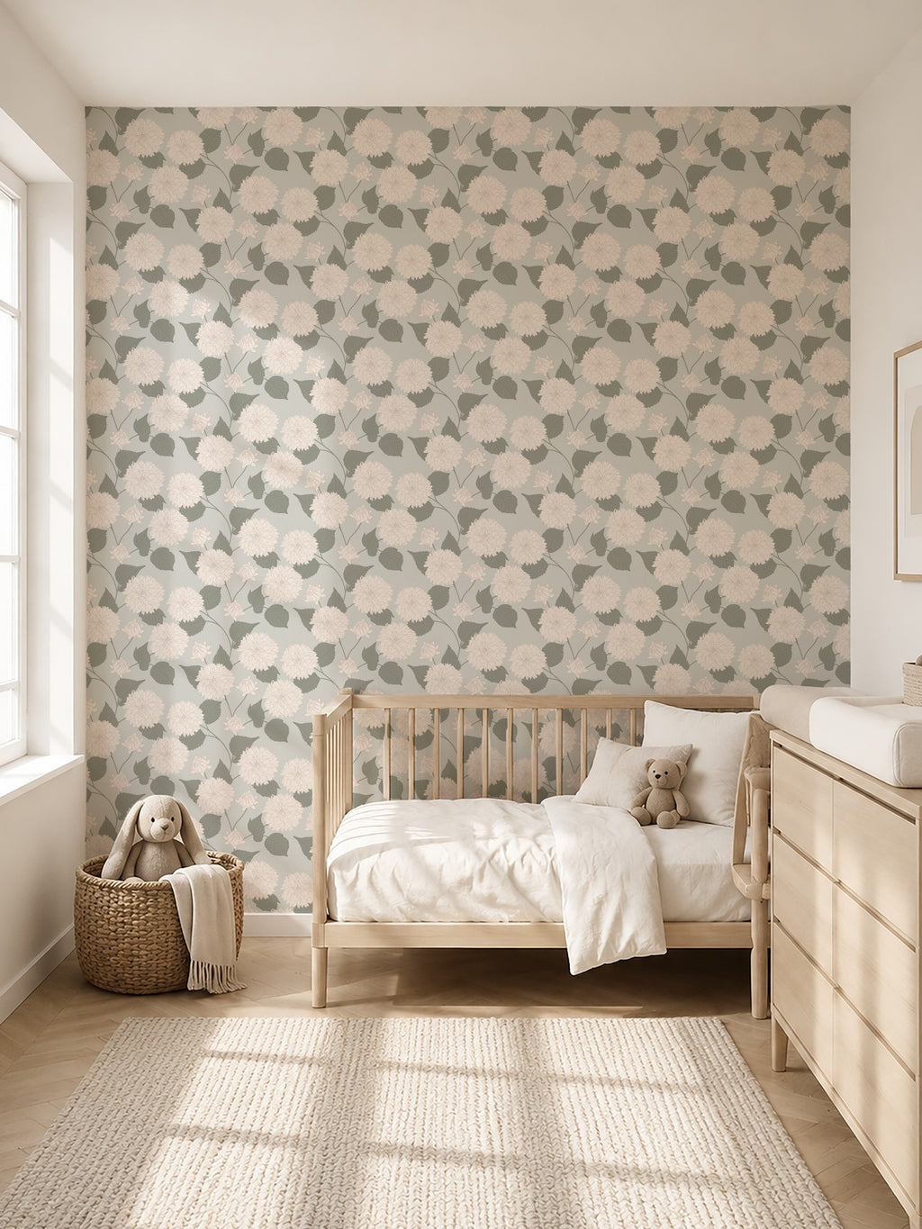 Dahlia Sage floral wallpaper with cream and blush motifs in a serene nursery setting.