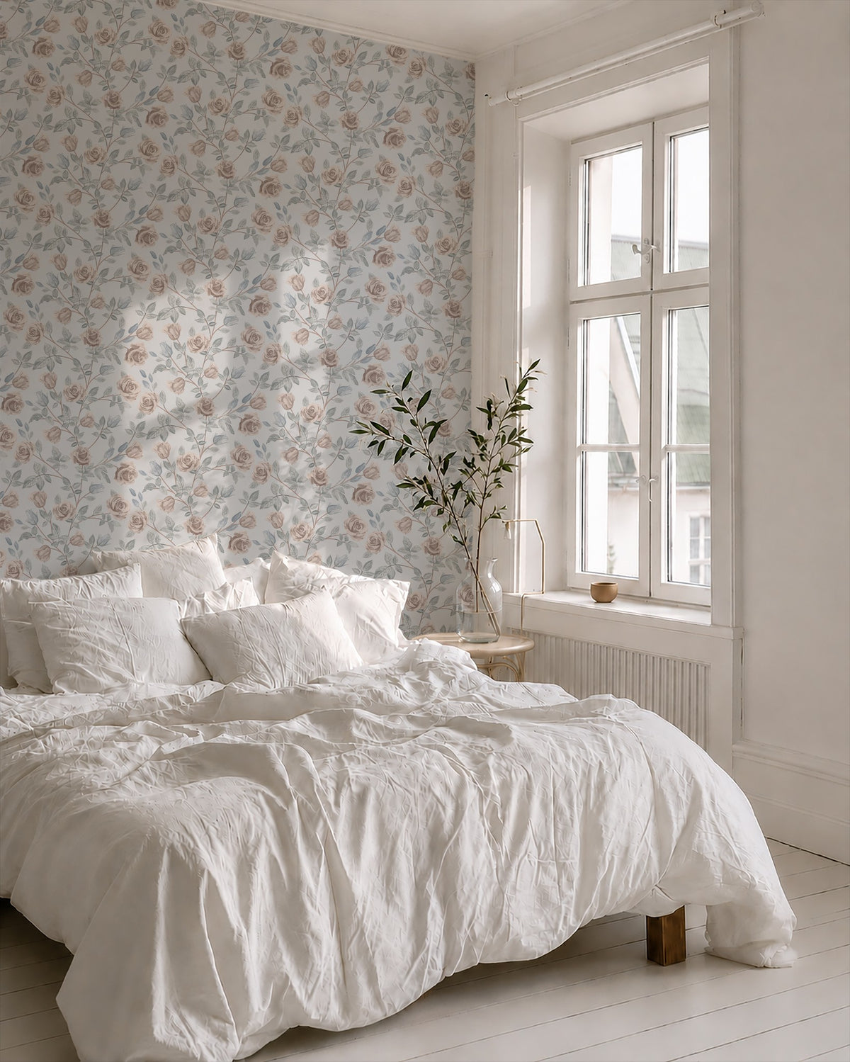 Dusty blue floral wallpaper with blush roses in a serene bedroom setting.