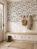 Floral dahlia wallpaper with sage background in a cozy entryway with bench and coat hooks.