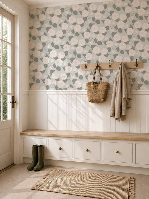 Floral dahlia wallpaper with sage background in a cozy entryway with bench and coat hooks.