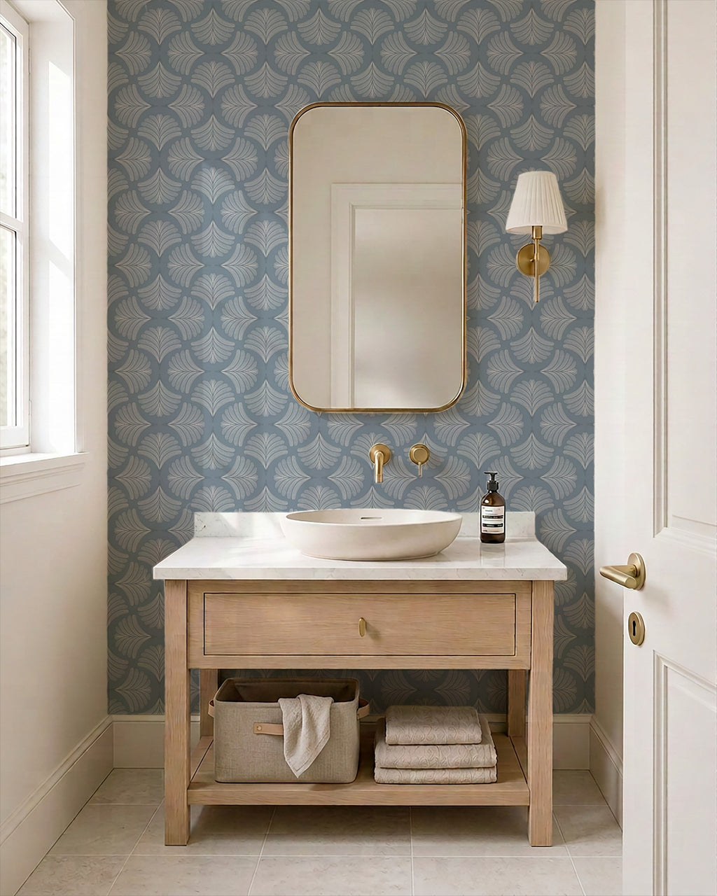Moody blue palm fan wallpaper in elegant bathroom with wooden vanity and gold accents.