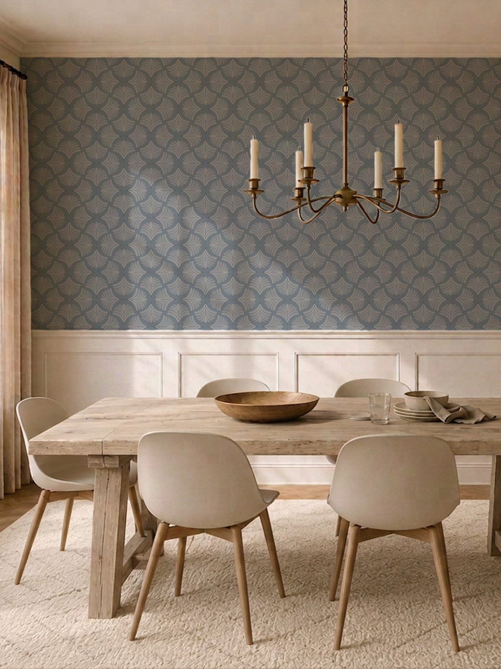 Dining room with moody blue palm fan wallpaper and elegant chandelier.