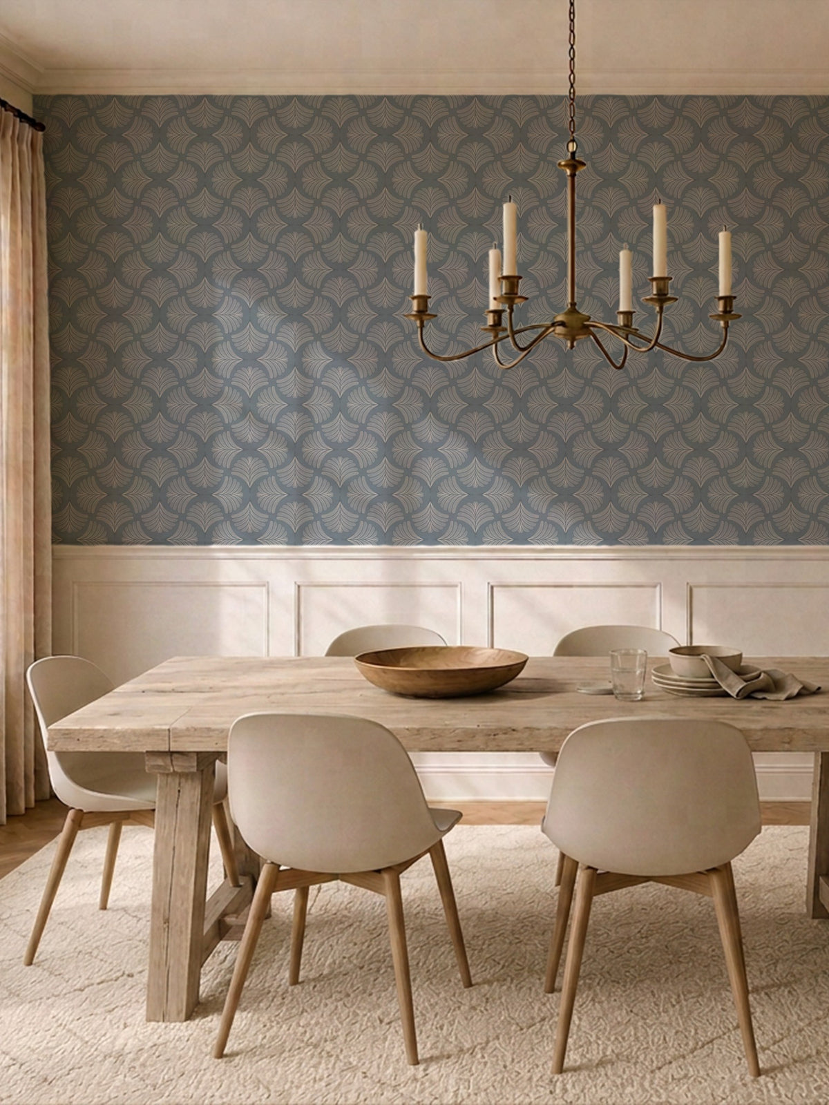 Dining room with moody blue palm fan wallpaper and elegant chandelier.