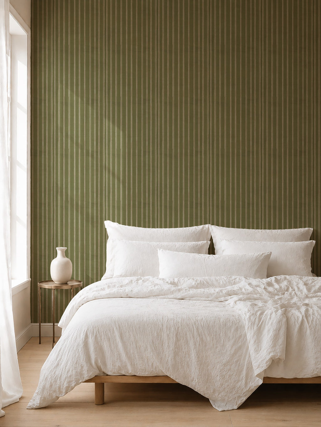 Olive and dusty pink striped wallpaper in a cozy bedroom with white bedding.