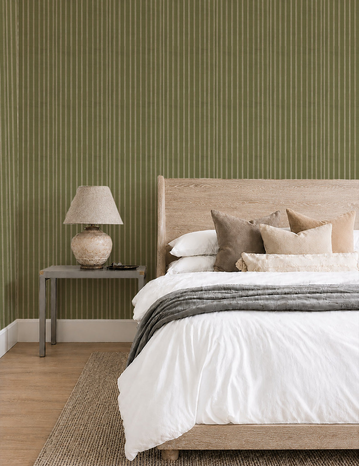Olive and dusty pink striped wallpaper in a cozy bedroom with neutral decor.