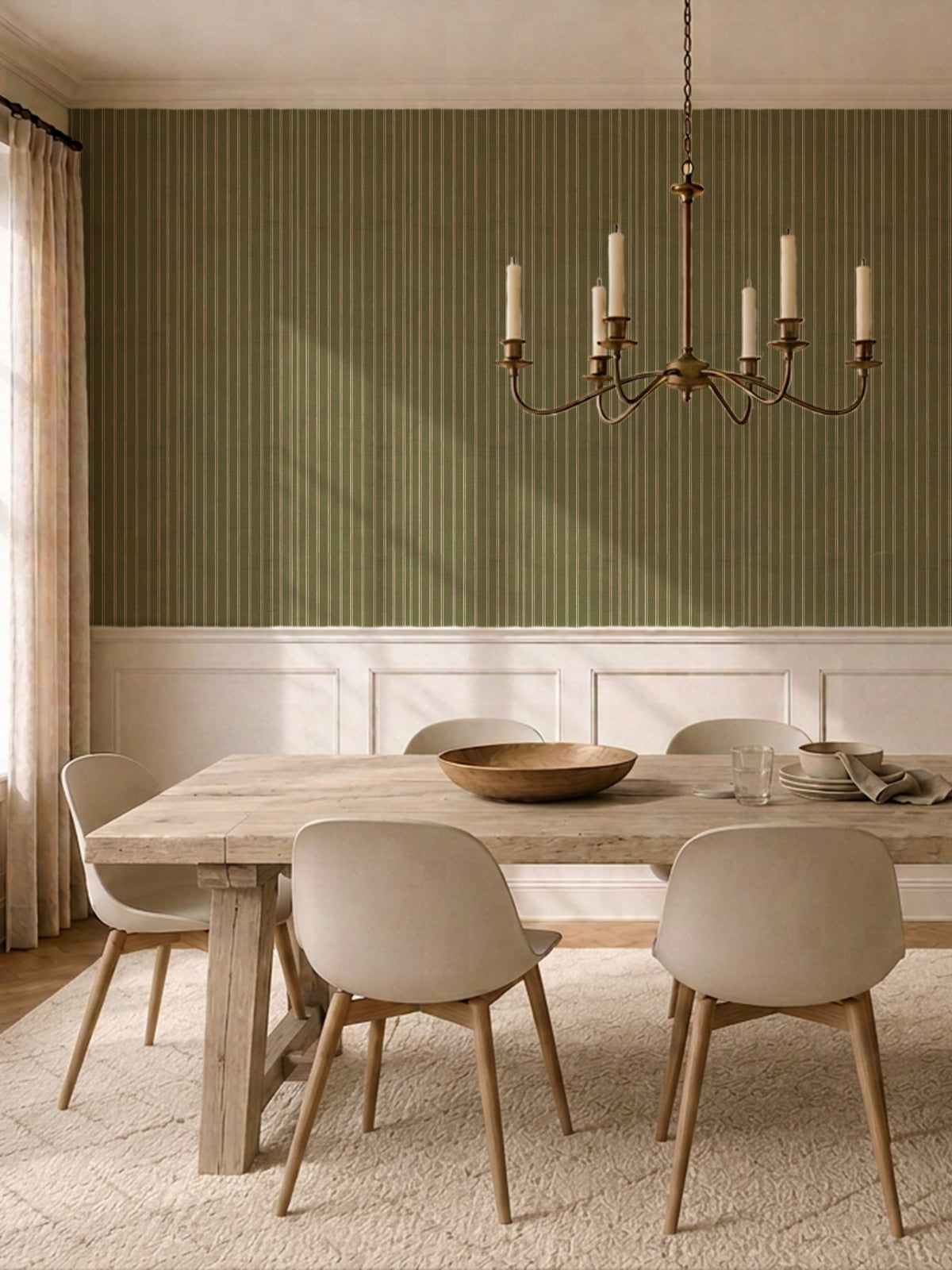 Olive and dusty pink striped wallpaper in elegant dining room with wooden table and chandelier.