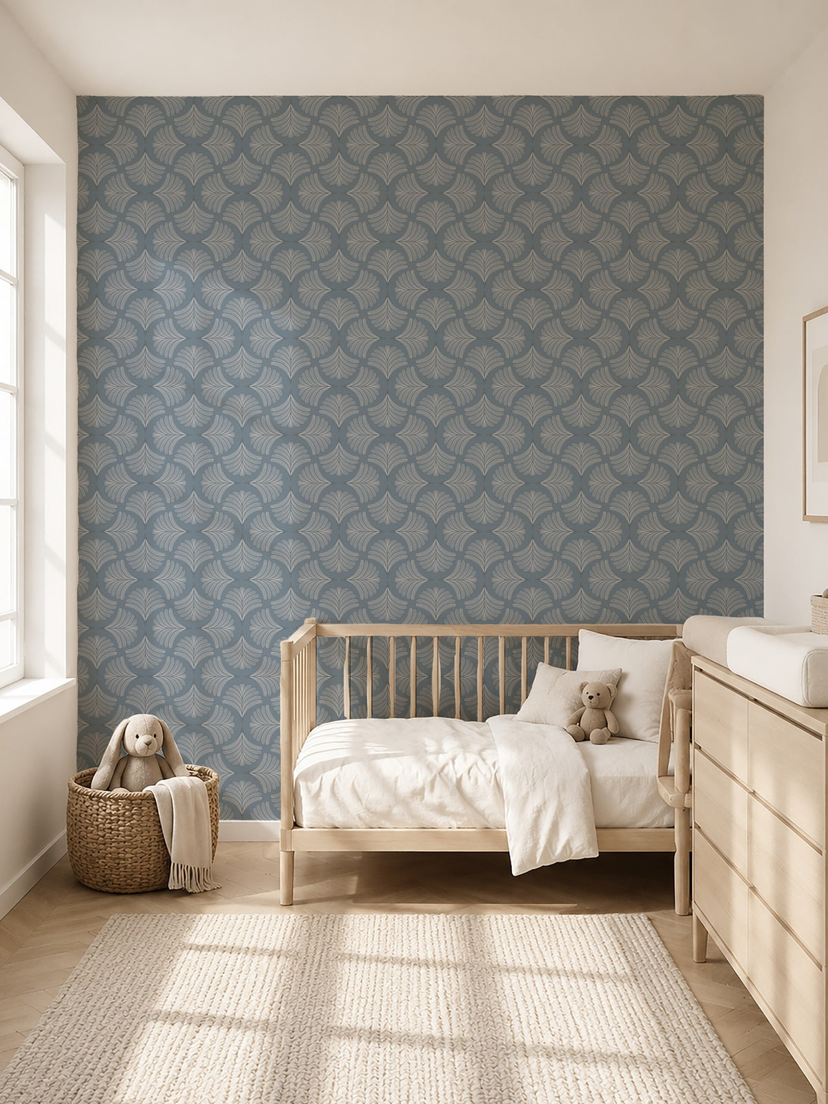 Palm Fans Moody Blue wallpaper in a serene nursery with wooden crib and dresser.