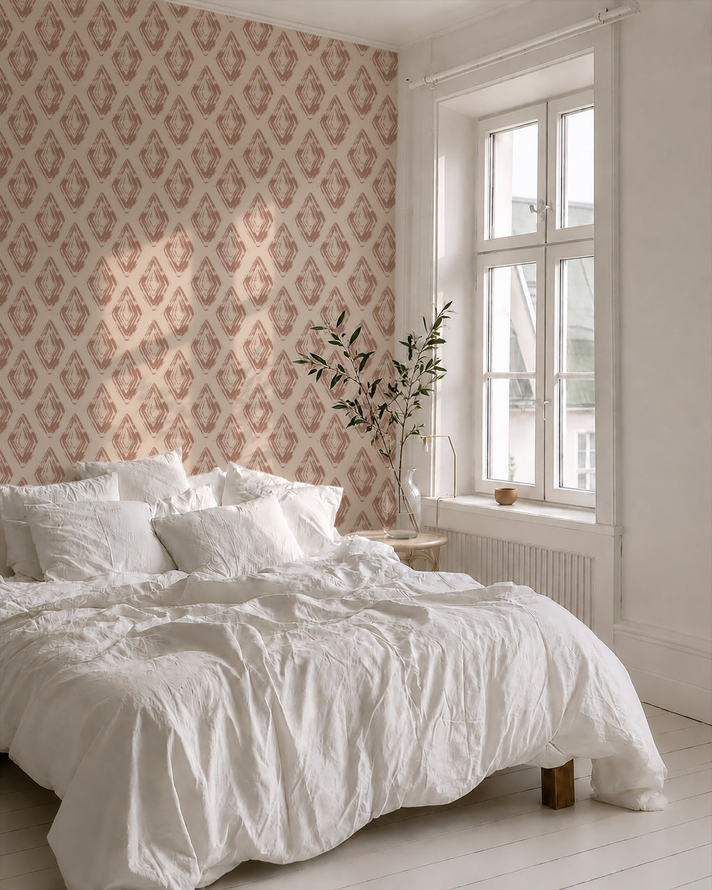 Bedroom with rose clay diamond block print wallpaper and white bedding.