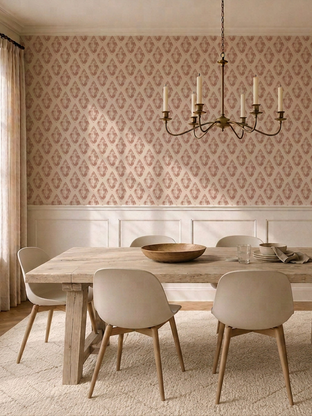Dining room with rose clay diamond block print wallpaper and wooden table.