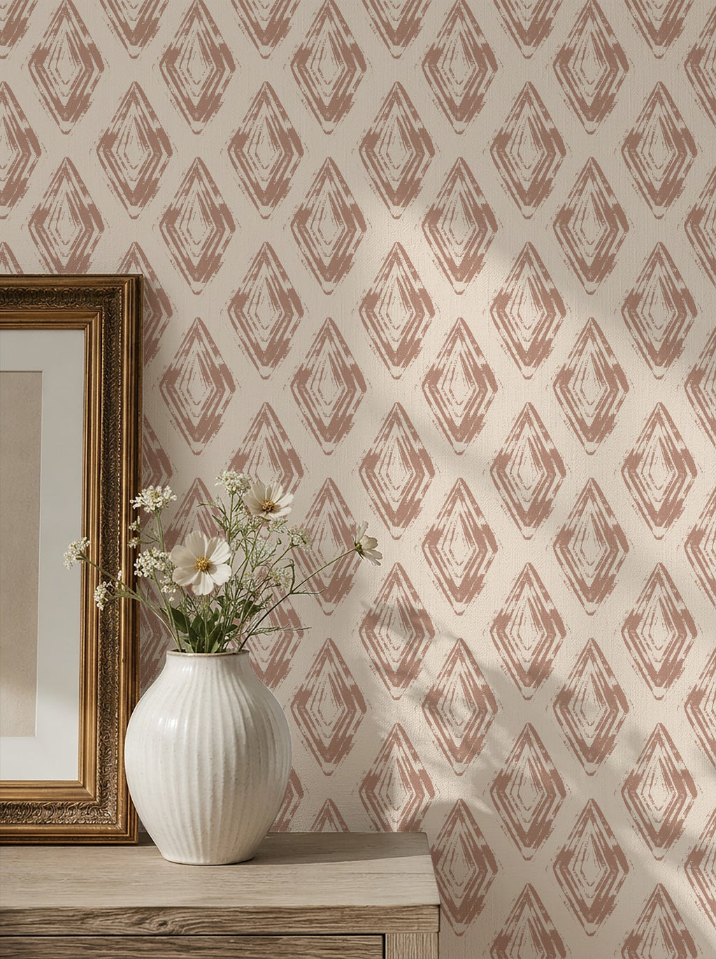 Rose clay diamond block print wallpaper in a room with vase and artwork.