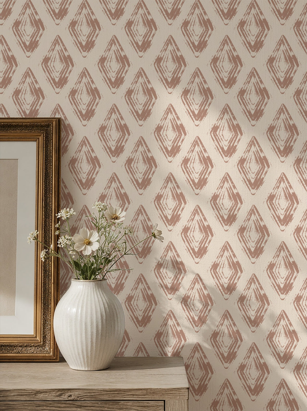 Rose clay diamond block print wallpaper in a room with vase and artwork.
