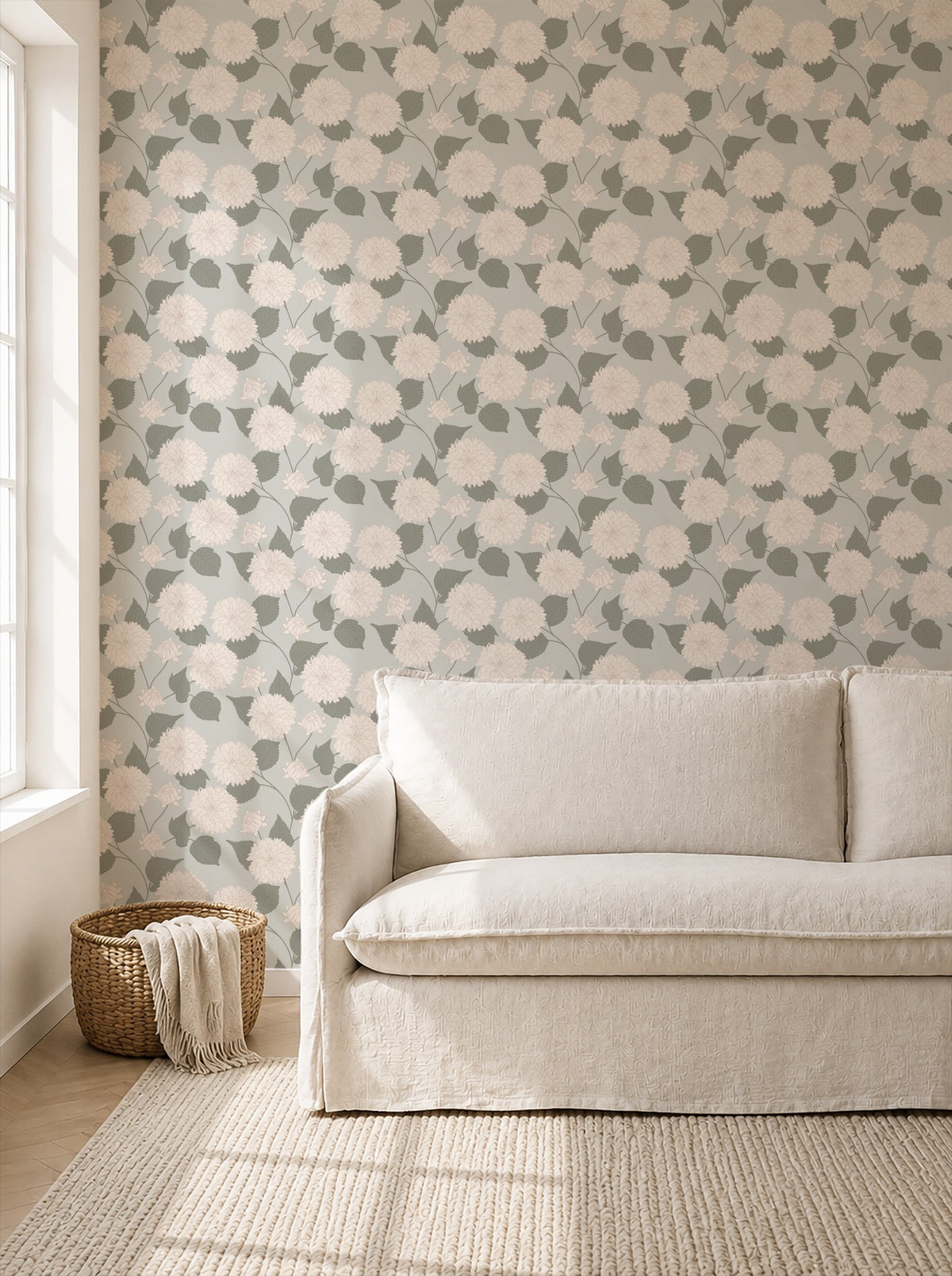Sage wallpaper with cream dahlia pattern in a cozy living room setting.