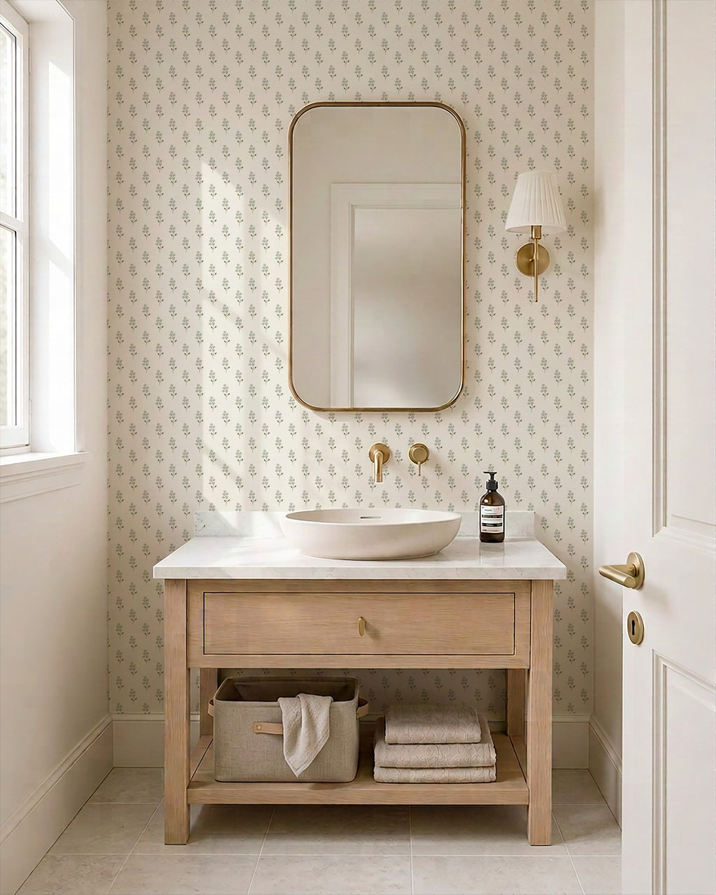Sage green floral wallpaper in a serene bathroom with light wood vanity and mirror.