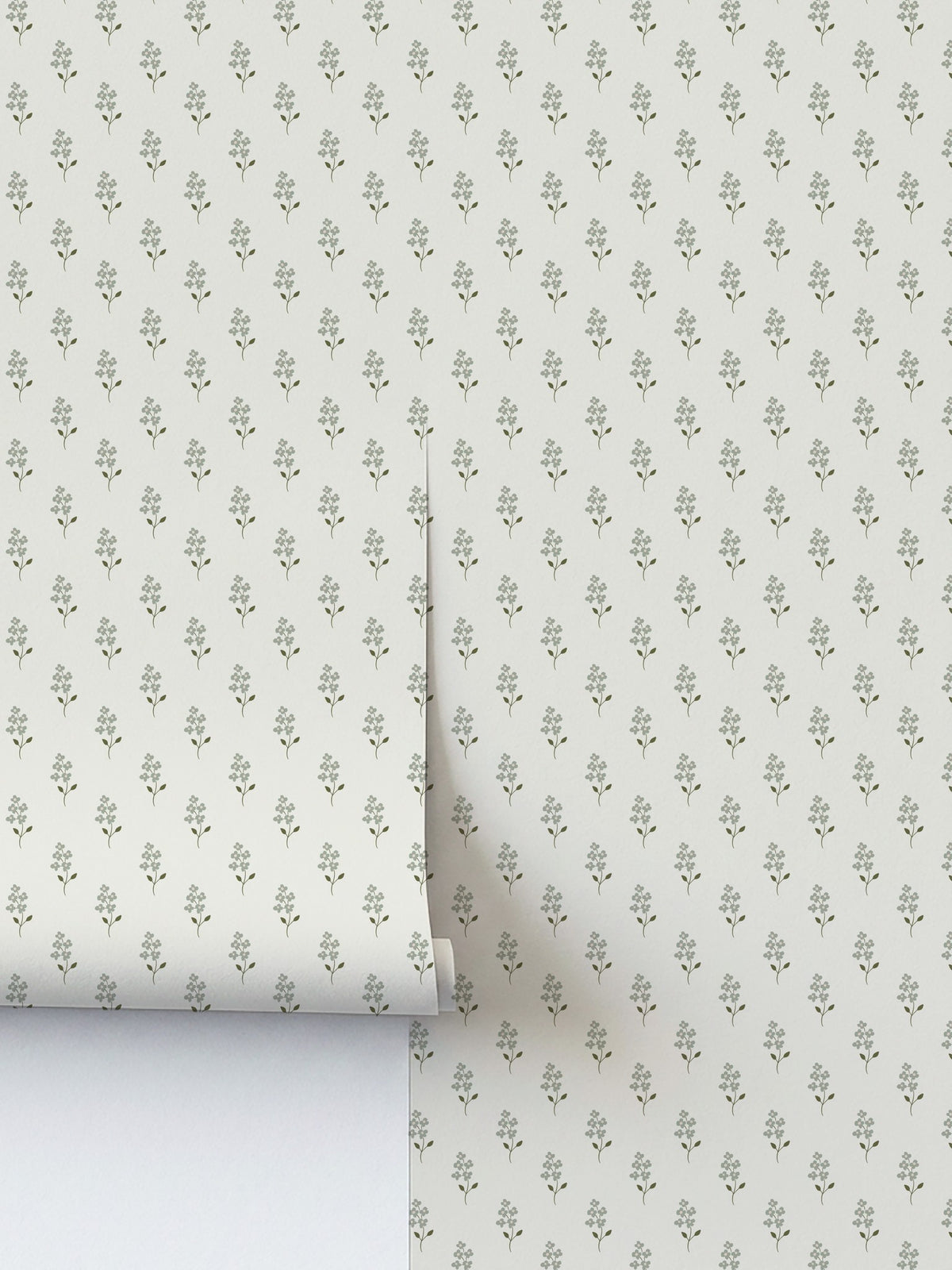 Sage green floral wallpaper with delicate blossoms on cream background.