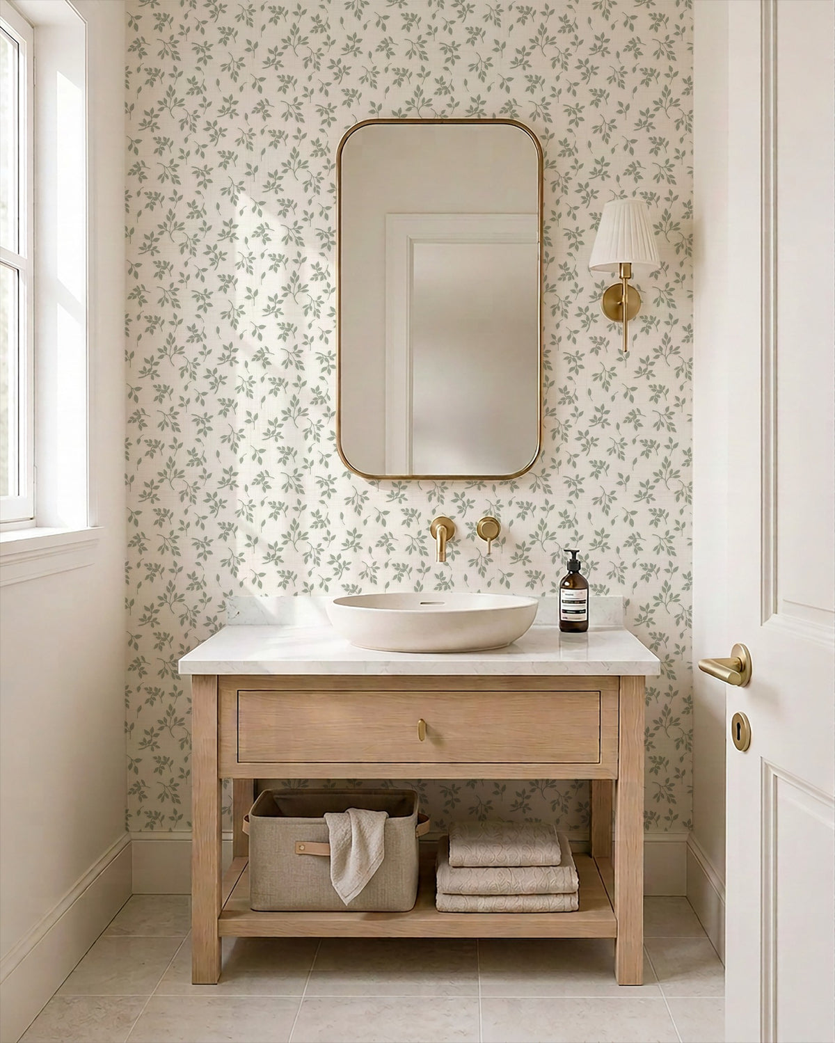 Sage green leaf sprig wallpaper in a serene bathroom with wood vanity.