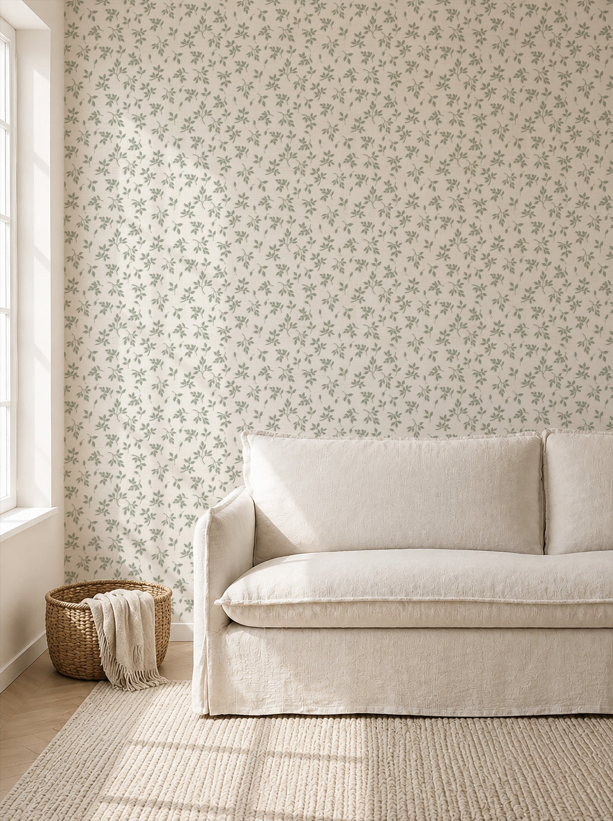 Sage green leaf sprig wallpaper in a bright living room with beige sofa.