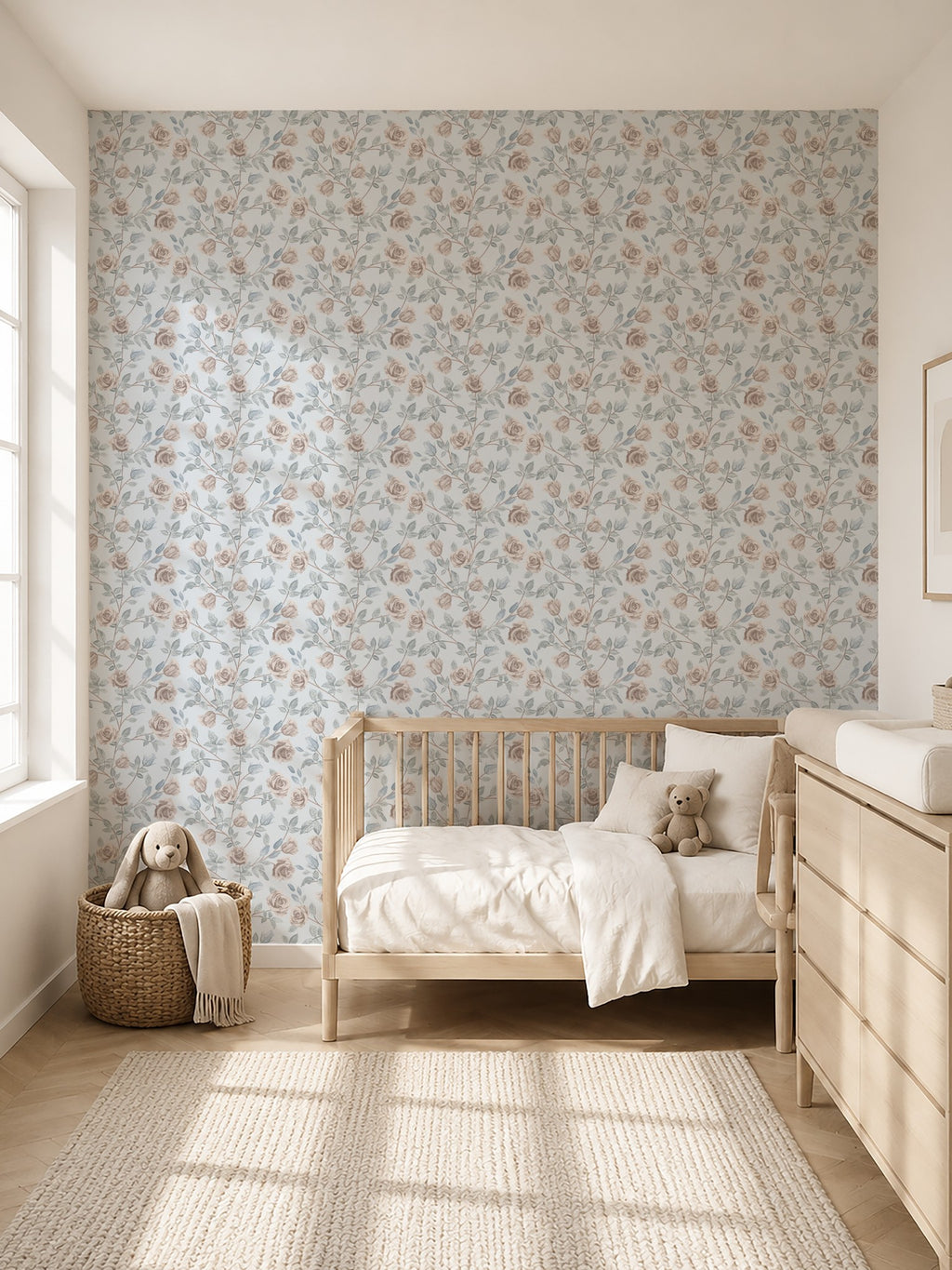 Vintage rose dusty blue floral wallpaper in serene nursery with wooden crib and dresser.