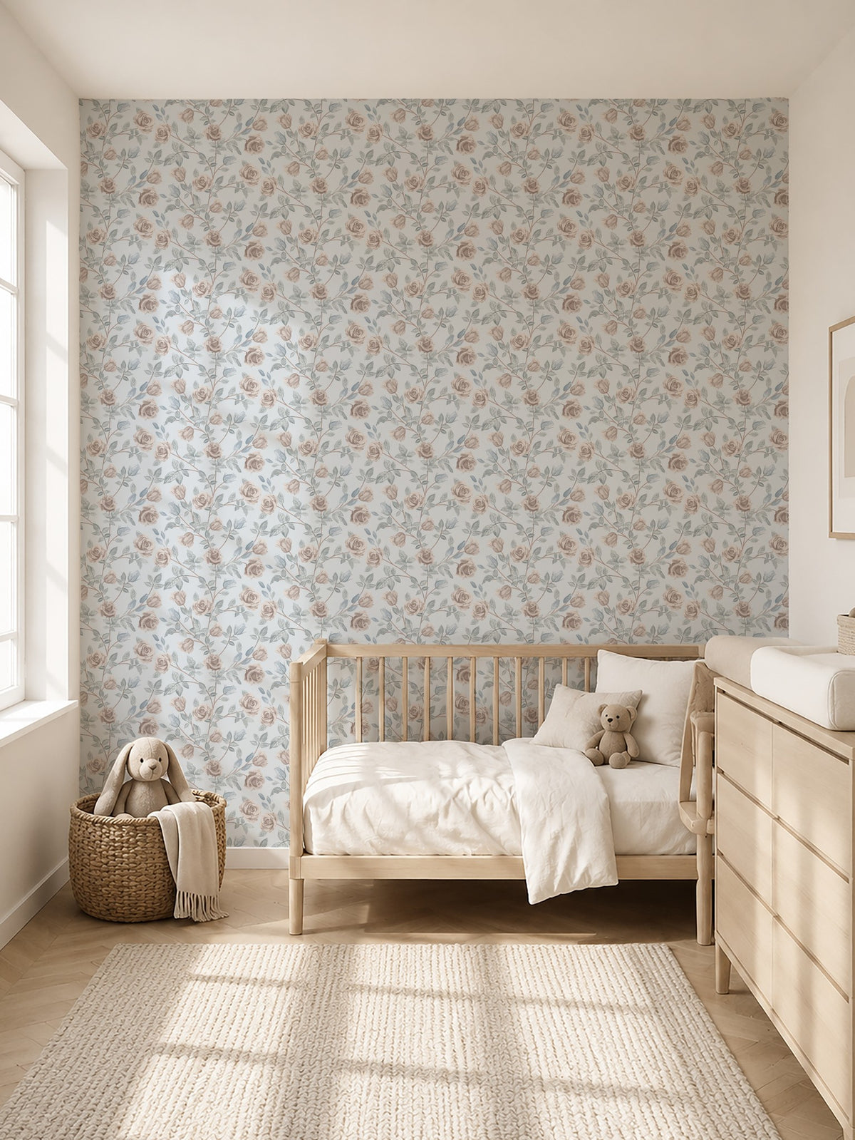 Vintage rose dusty blue floral wallpaper in serene nursery with wooden crib and dresser.