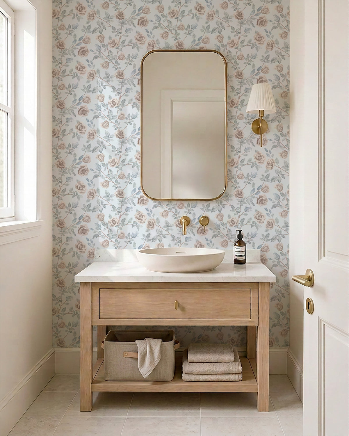 Dusty blue wallpaper with blush roses in a vintage bathroom setting.